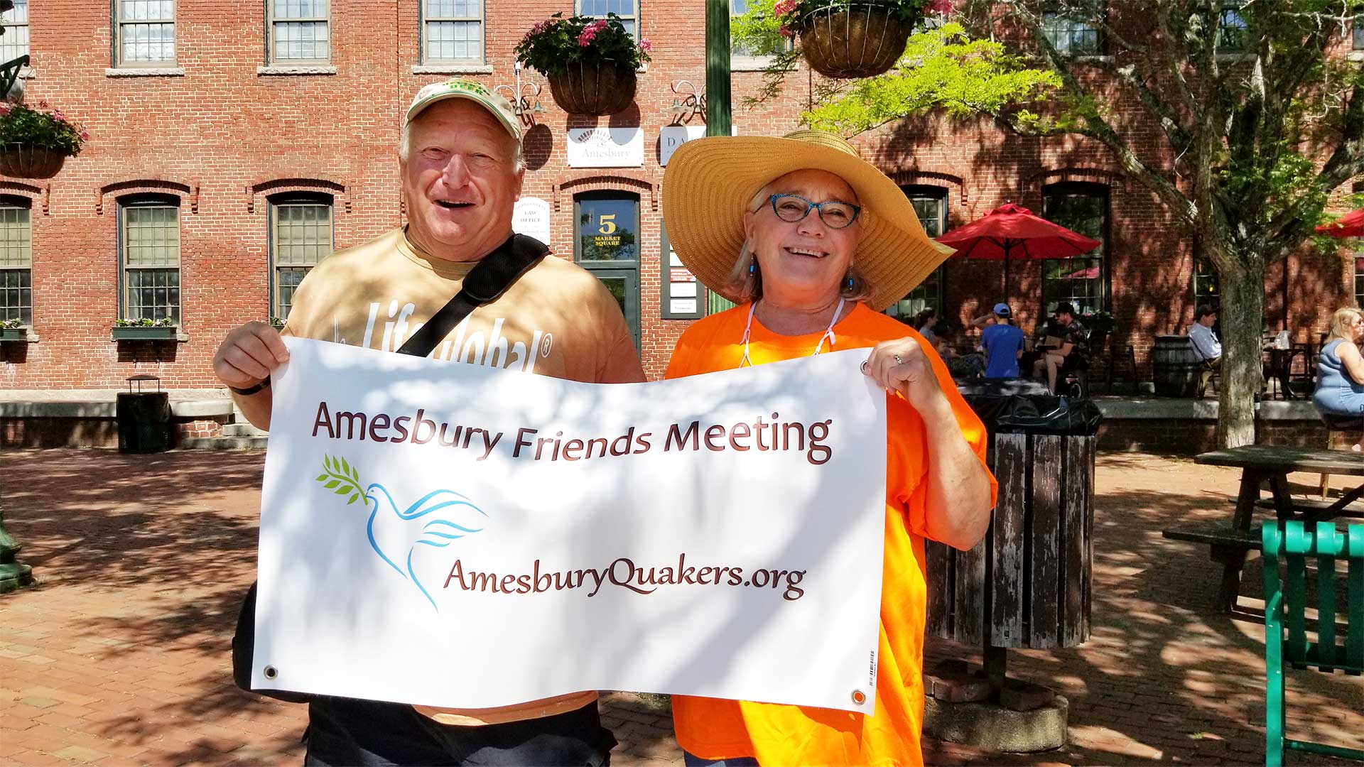 FB--Cover-Tim-Edith-Banner2021_1920x Tim and Edith holding banner - Amesbury Friends Meeting