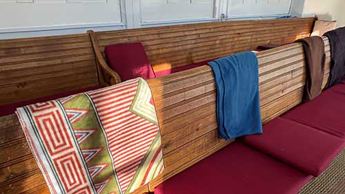 AFM benches with blankets draped over backs