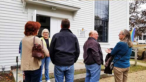 Friends standing in front of Meetinghouse